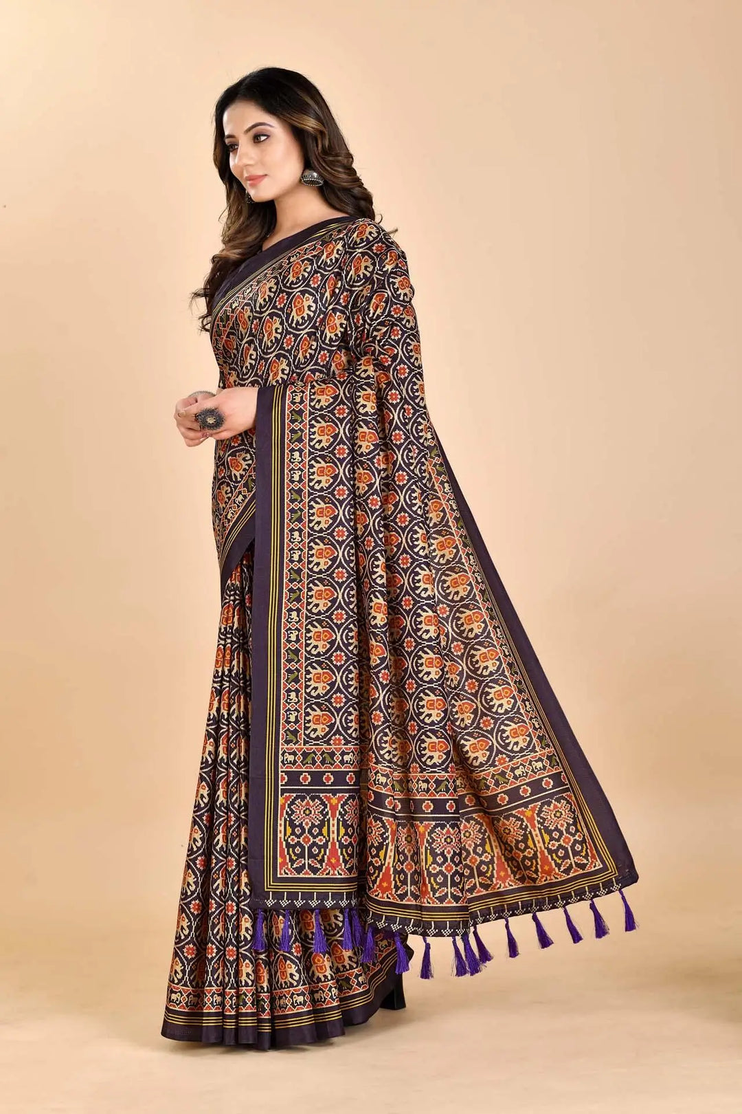 Woman wearing a Elephant Patola printed Saree.