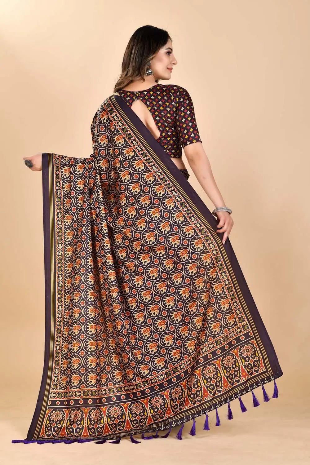 Woman wearing a Elephant Patola printed Saree.