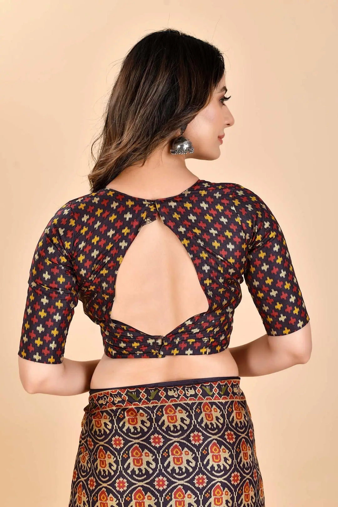 Woman wearing a Patola printed saree Blouse.