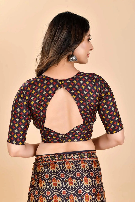 Woman wearing a Patola printed saree Blouse.