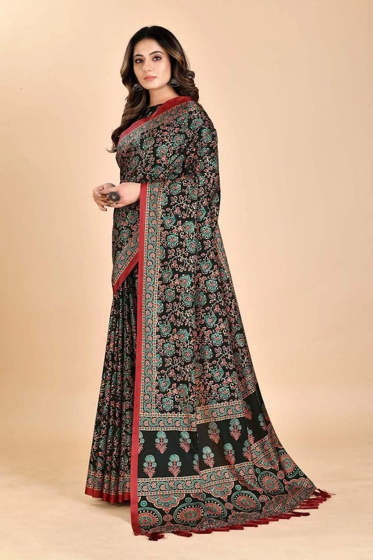 Woman wearing a black Ajrakh printed saree with a red border.