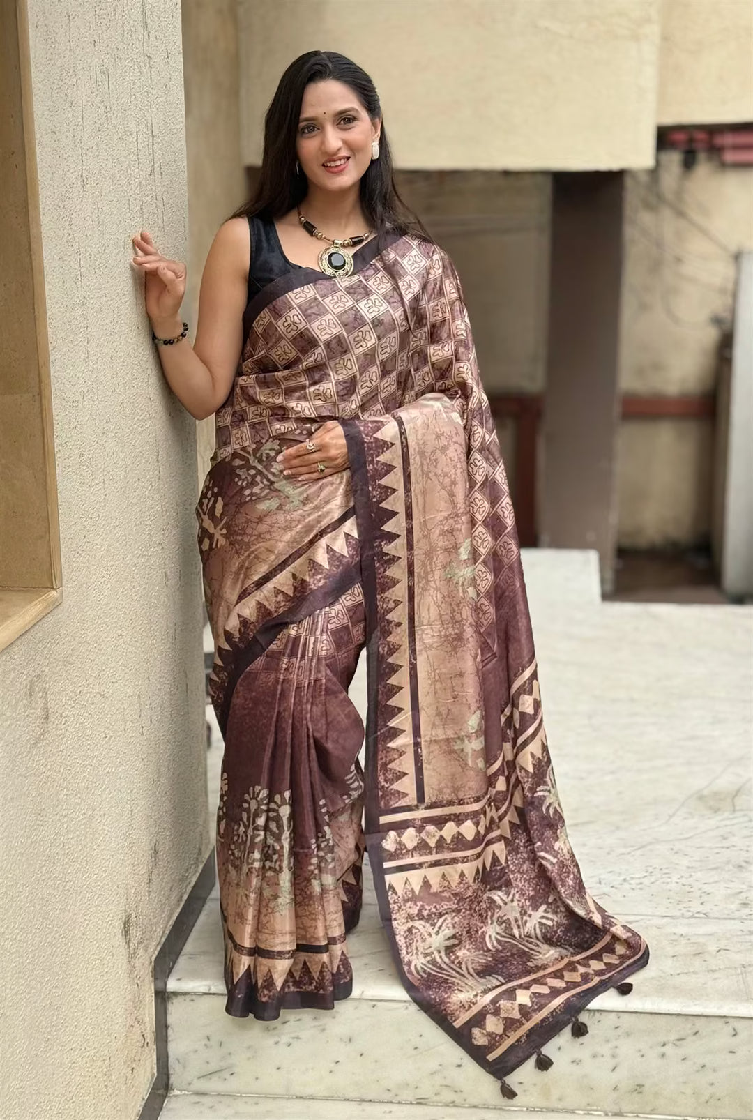 Woman wearing a brown toned Geometric print saree.