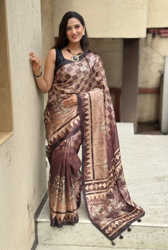 Woman wearing a brown toned Geometric print saree.