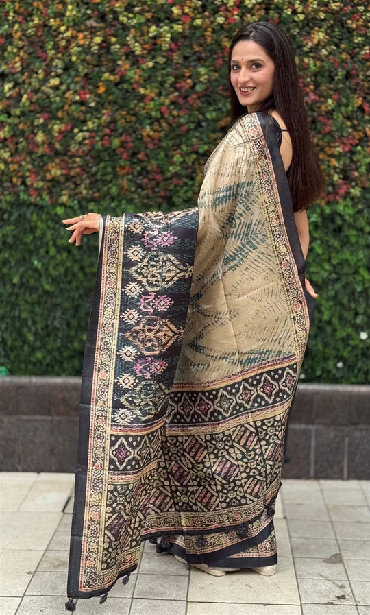 Woman wearing a multicolour Ikkat printed saree.