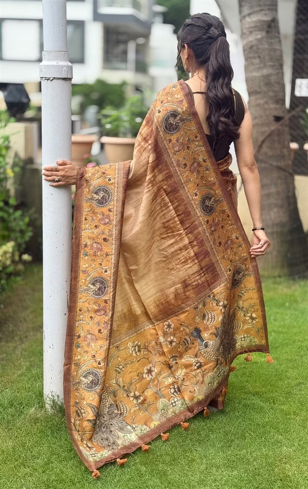 Woman in peacock pallu printed saree.