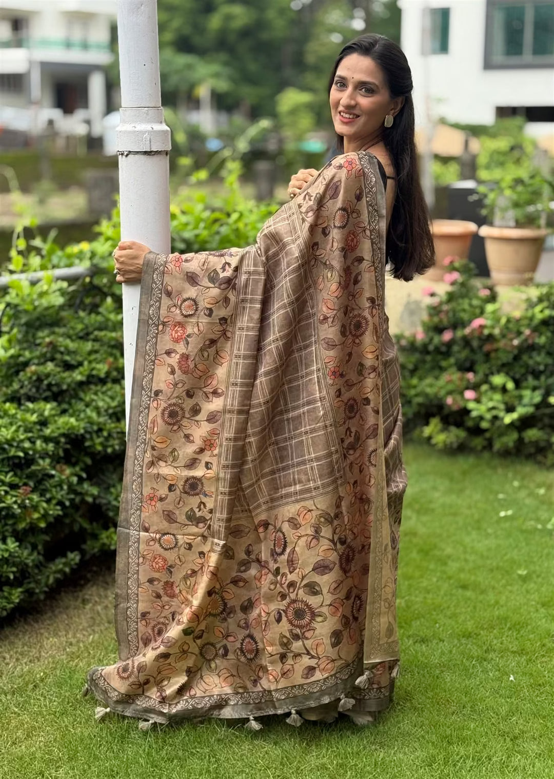 Woman in Floral Border with Checks Pattern saree.