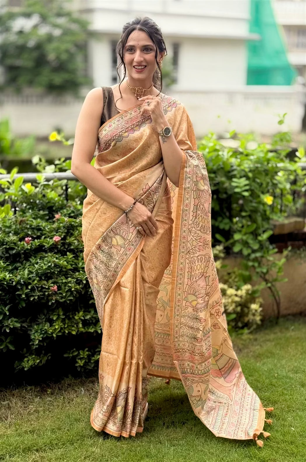 Woman wearing a Mustard Matsya Madhubani printed saree.