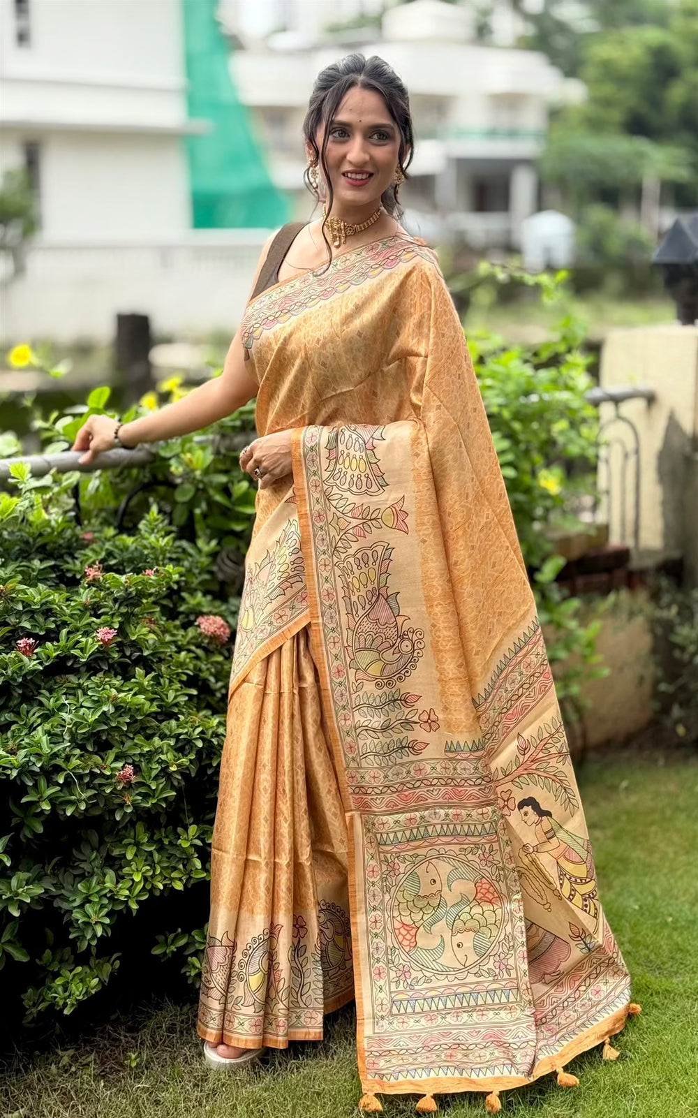 Woman in Mustard Matsya Madhubani print saree.
