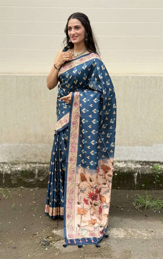 Woman wearing a Blue Colour Ikkat Butti with Floral Pallu print saree.