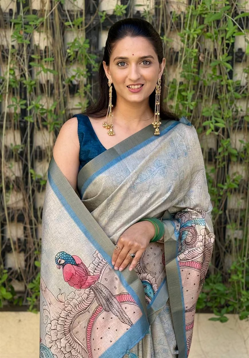 Woman wearing a traditional saree with a Bird design.