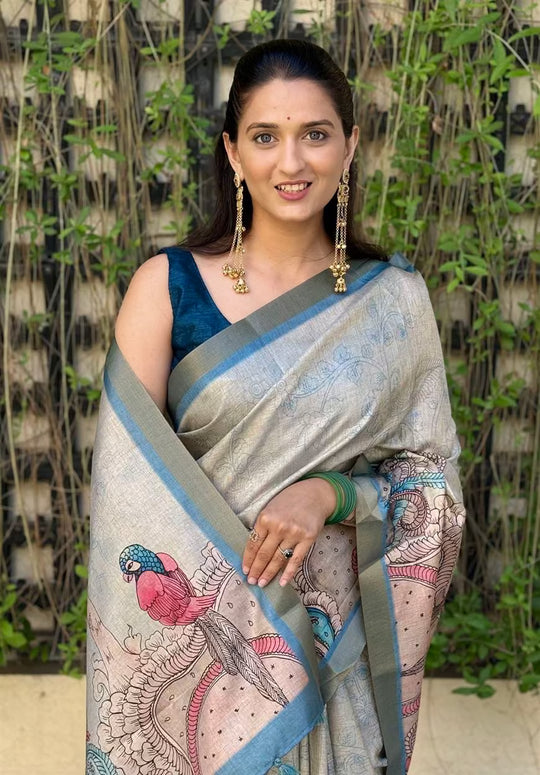 Woman wearing a traditional saree with a Bird design.