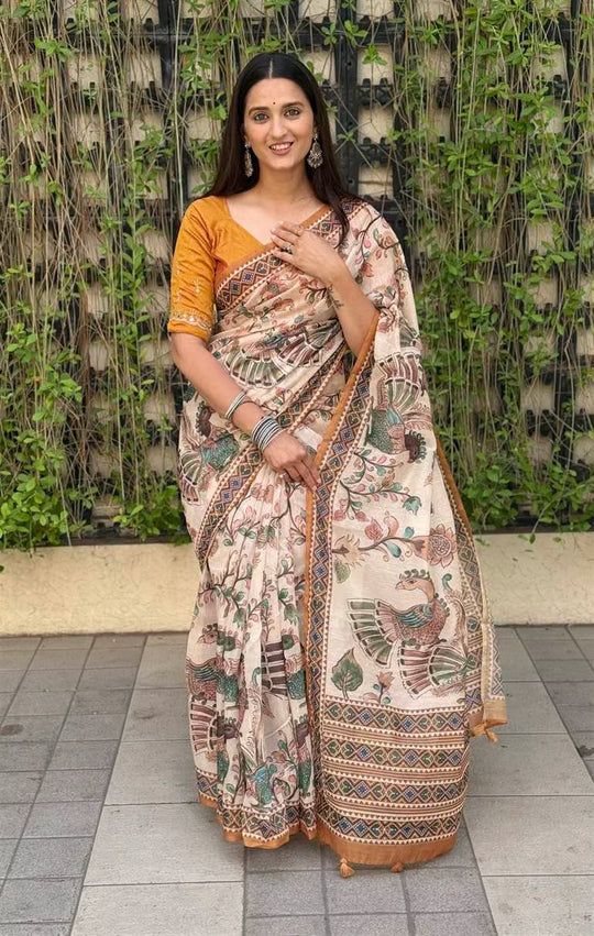 Woman wearing Kalamkari Print saree in Beige with Solid Mustard Border by Ethnic Today.