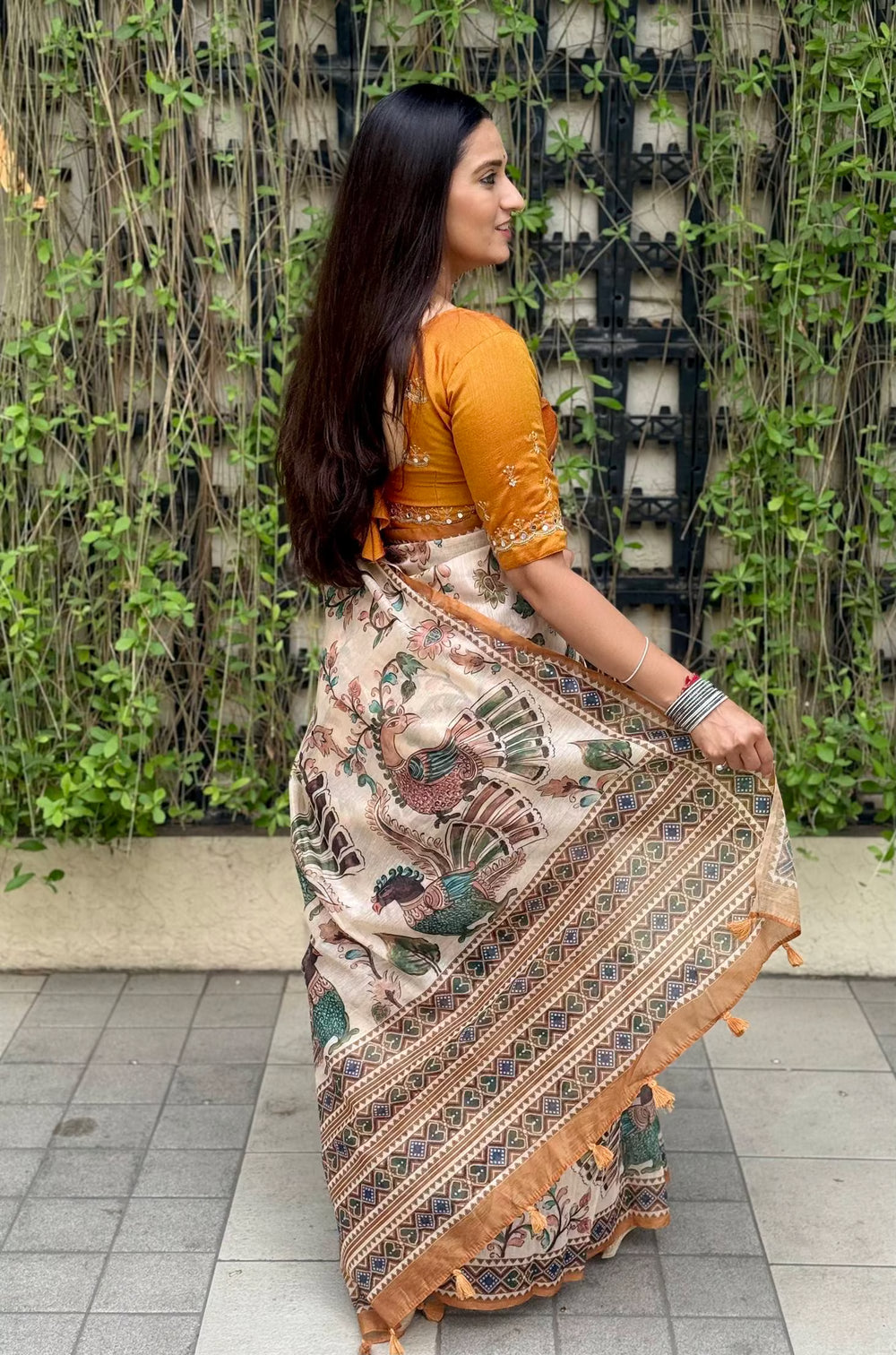 Woman wearing Kalamkari Print Mustard colour Saree.