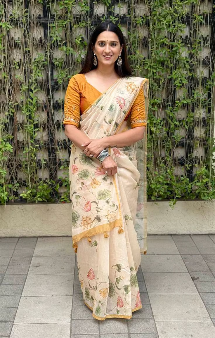 Woman in Yellow Solid Border with cream Colour in Floral Print Saree.