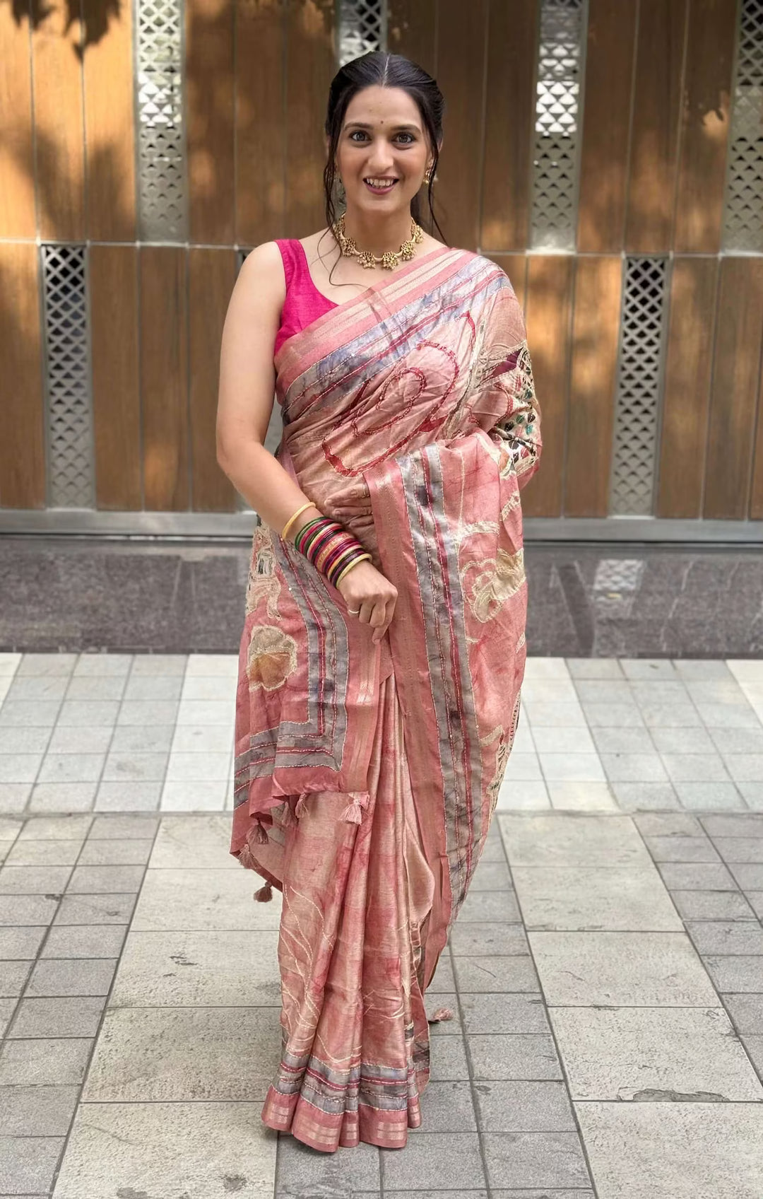 Woman wearing Rosewood Pink Kalamkari Art Pallu Silk Saree with Zari border.