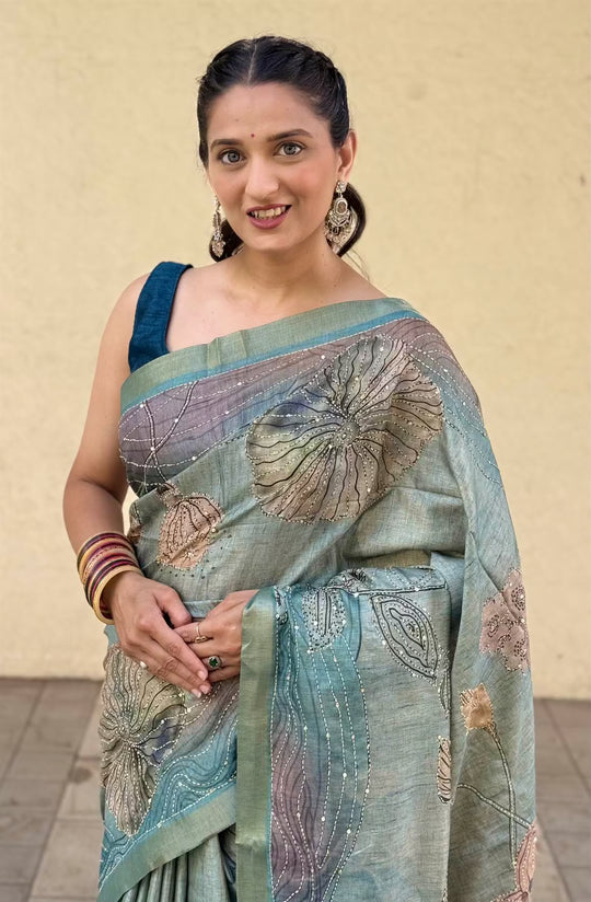 Woman wearing Aqua Cyan Floral Katha Dola Silk Saree.