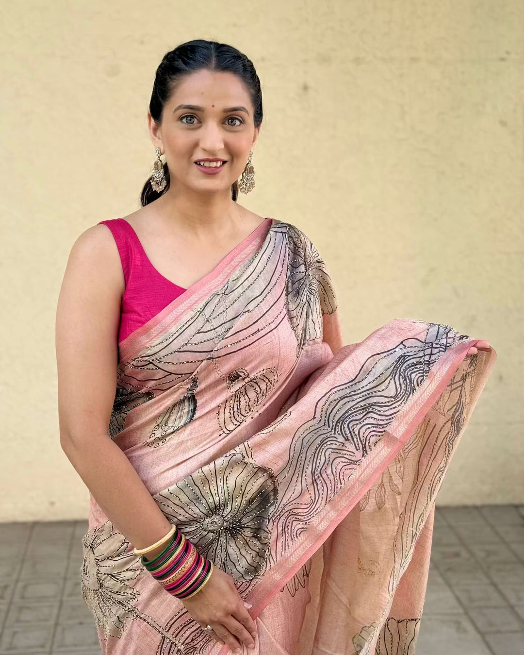 Woman wearing Dusty Rose Botanical Katha Dola Silk Saree.
