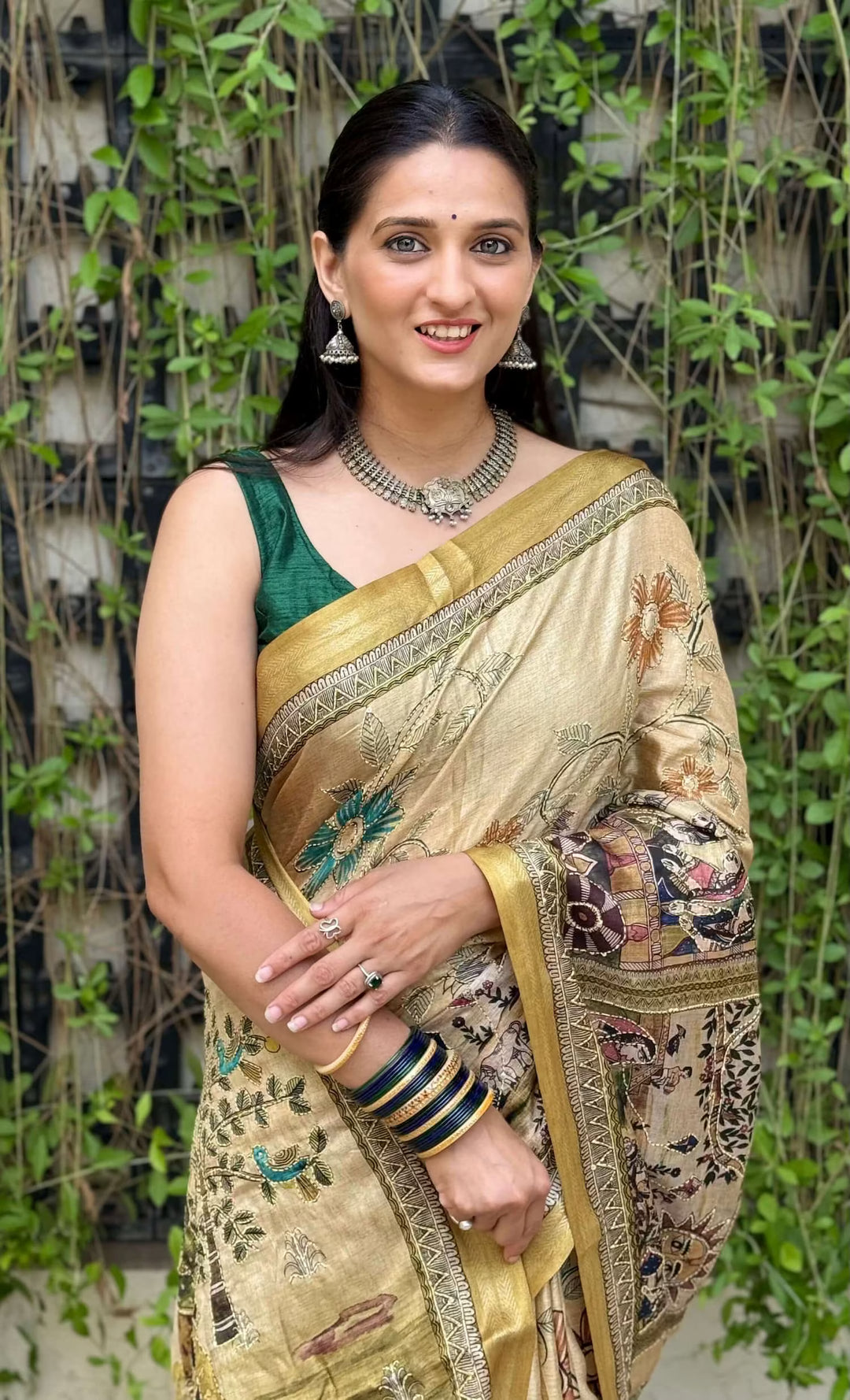 Woman in Mustard Gold Madhubani Dola Silk Saree.