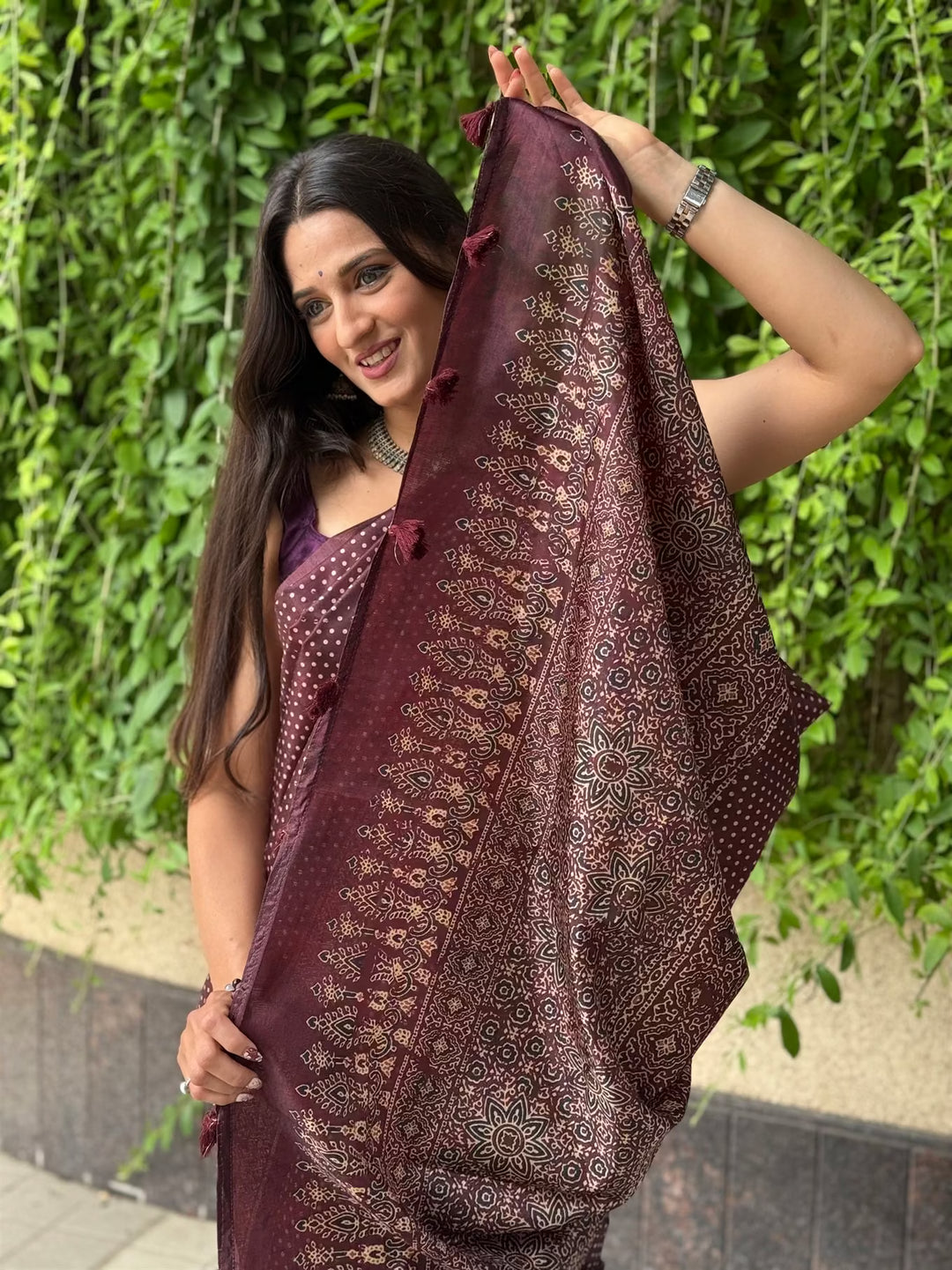 Woman in Polka Dot Dark Maroon with Ajrakh pallu saree.