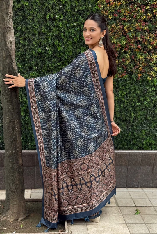 Woman in Ajrakh Pallu Border With Dot & Floral Butti saree.