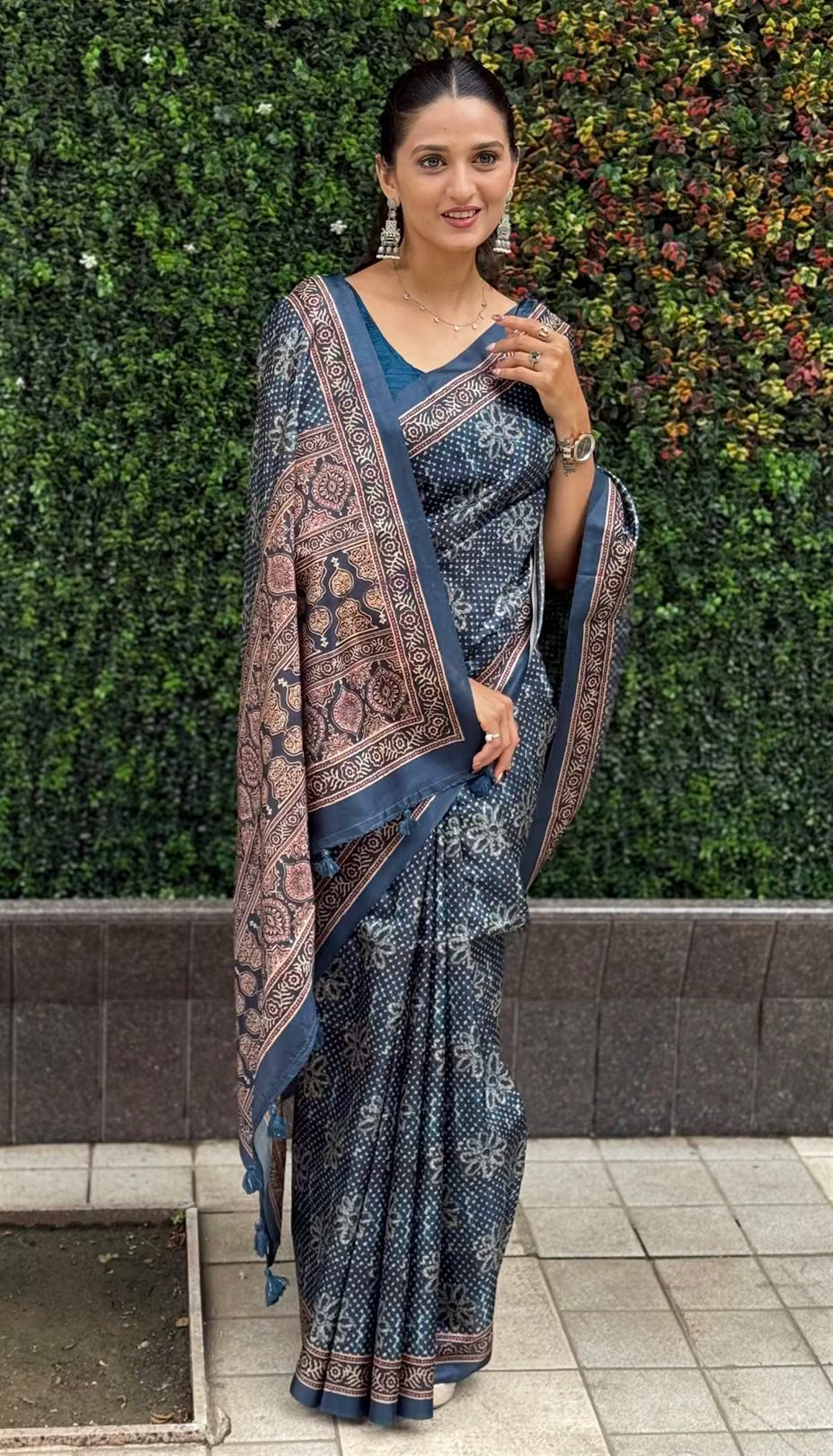 Woman wearing a Ajrakh Pallu Border With Dot & Floral Butti Tussar silk saree.