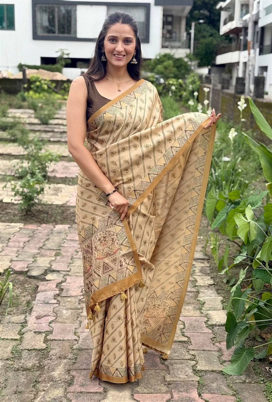 Woman wearing a Printed saree with Madhubani style border.