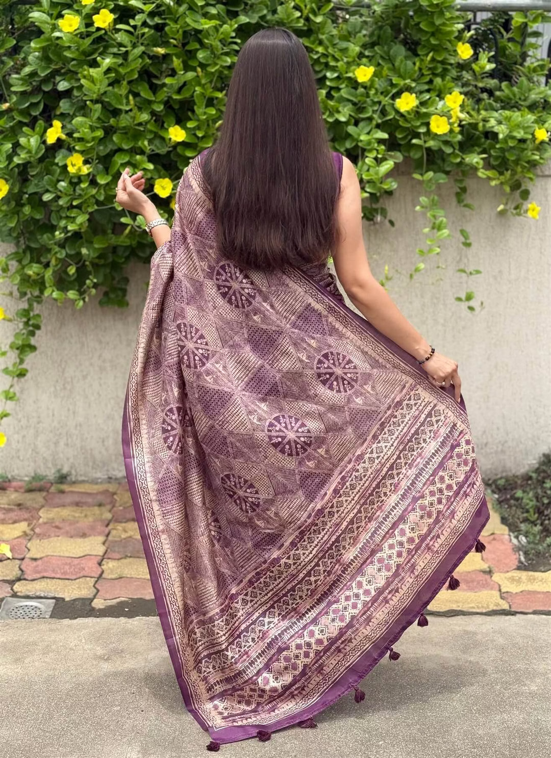 Woman in Purple Base with Geometric Beige Pattern saree.
