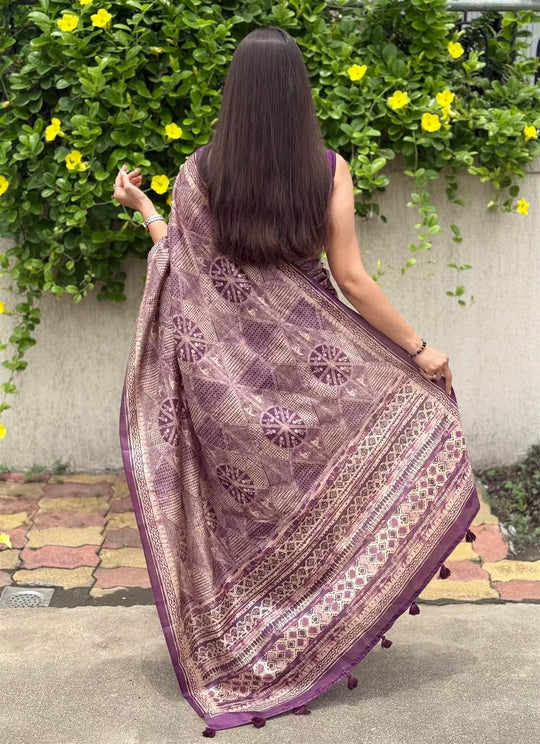 Woman in Purple Base with Geometric Beige Pattern saree.