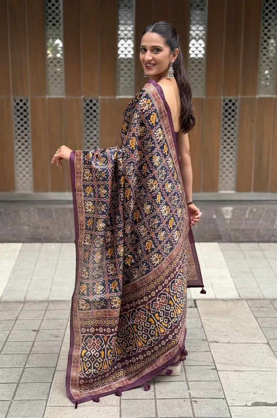 Woman wearing a Patola print Navy Blue Colour saree.