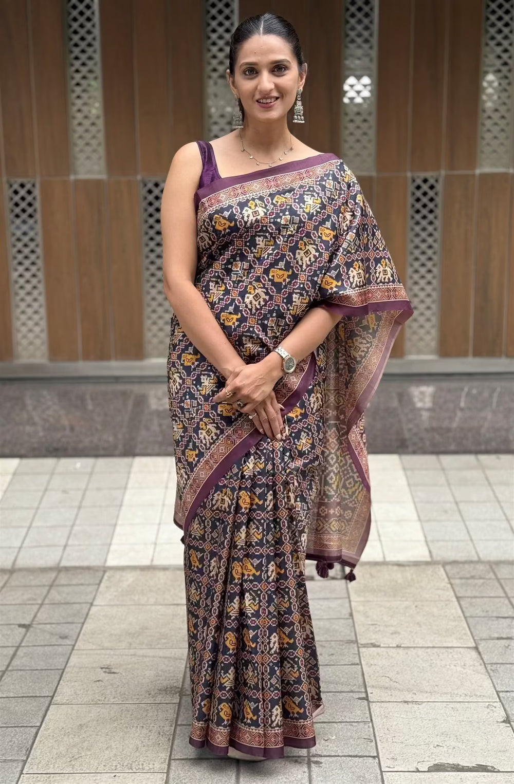 Woman in Patola print Navy Blue Colour saree.