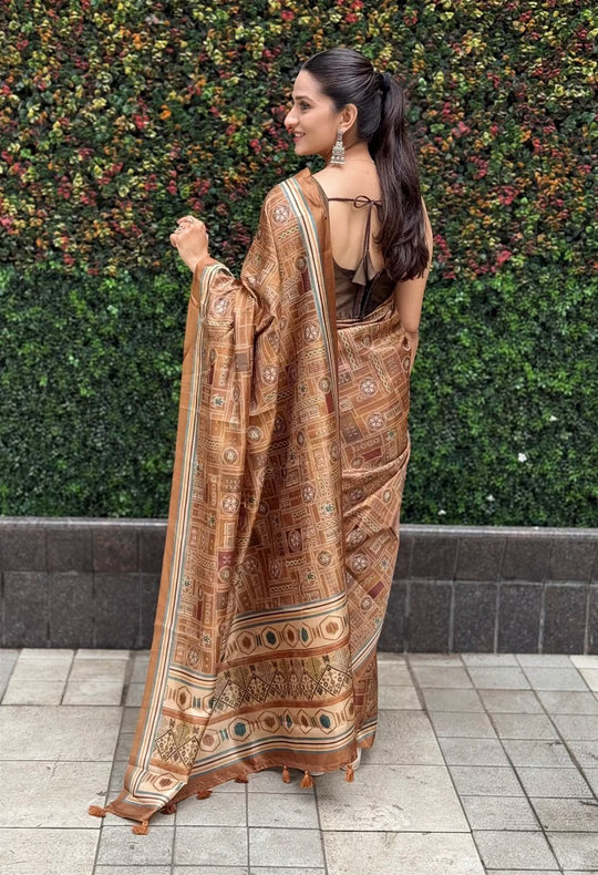 Woman in Brown shade with Geometric and Tribal inspired motif saree.