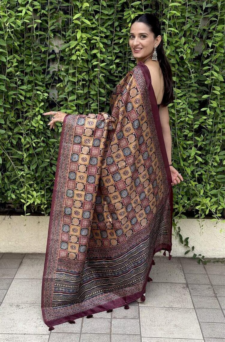 Woman in Multi Colour Ajrakh Print with Maroon border saree.