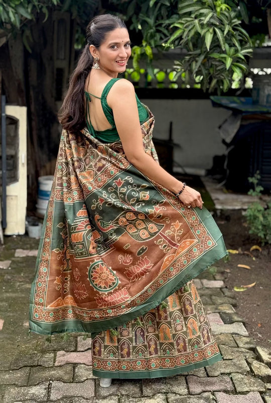 Woman in Green & Brown pallu with Peacock and Temple style motifs.