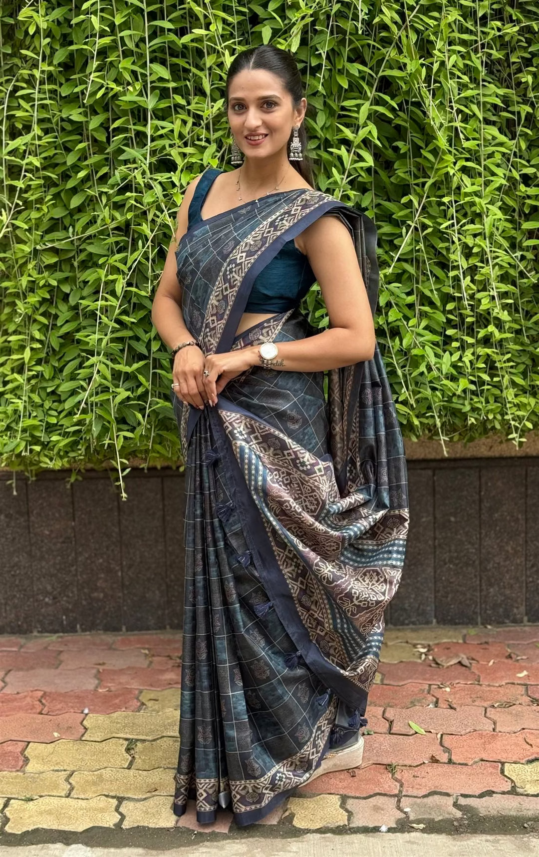Woman wearing a Navy Blue Ikkat Pallu Border Tussar Silk saree.