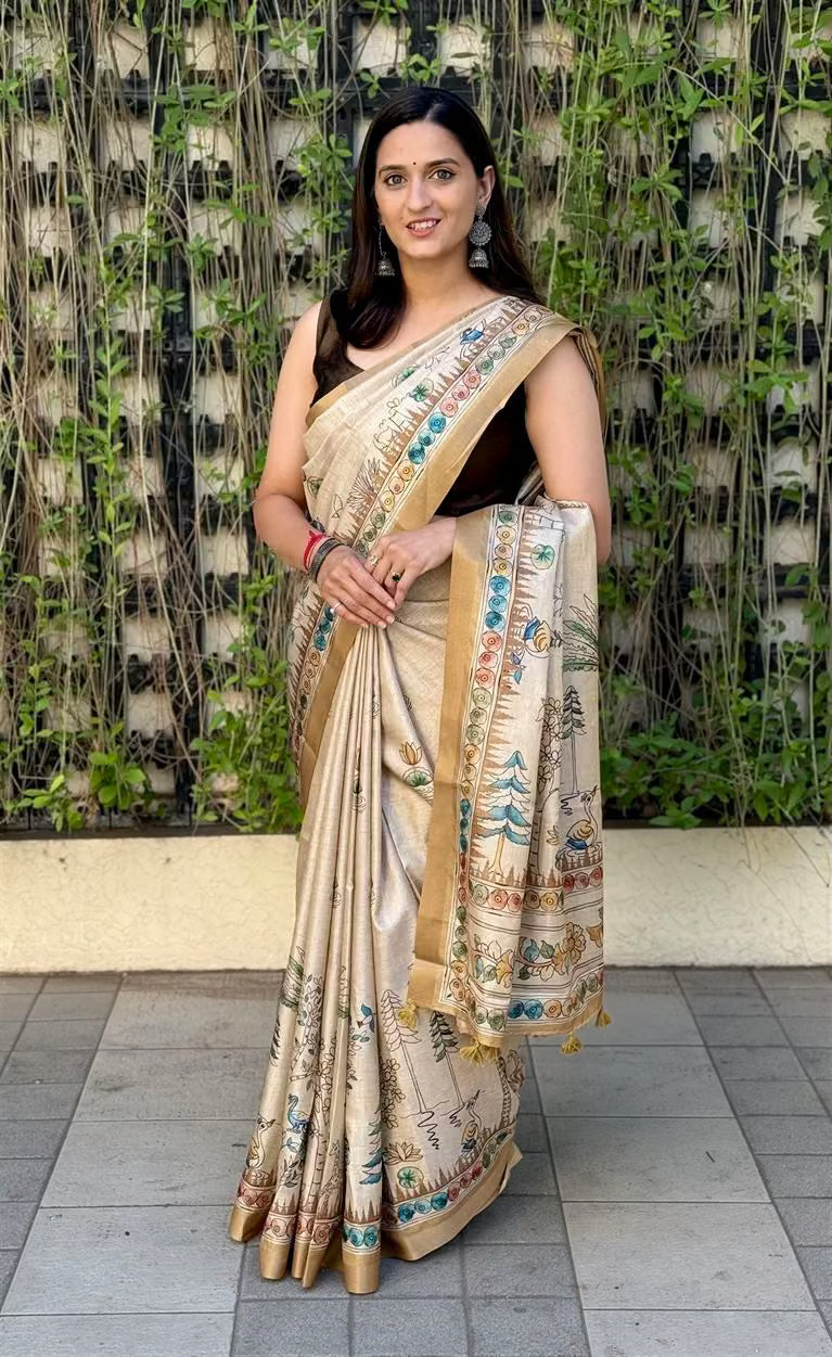 Woman wearing Cream Gold Saree in Kalamkari Print with Zari Border.