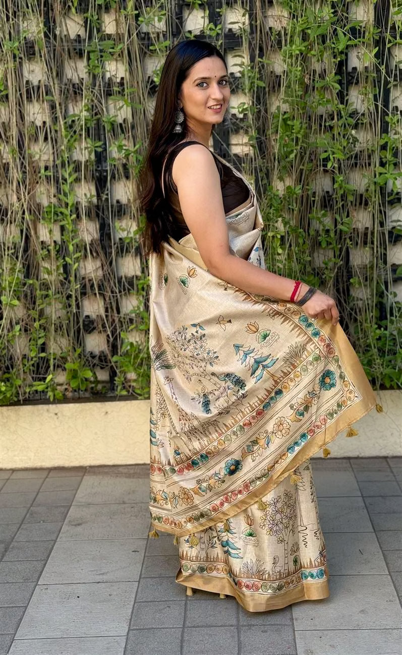 Woman wearing Cream Gold Saree in Kalamkari Print by Ethnic Today.