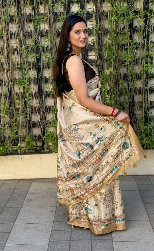 Woman wearing Cream Gold Saree in Kalamkari Print by Ethnic Today.