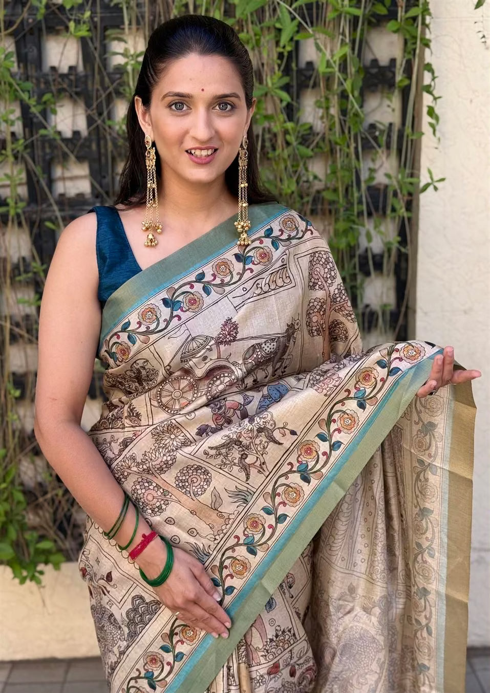 Woman in traditional Kalamkari print saree with Zari Border by Ethnic Today.