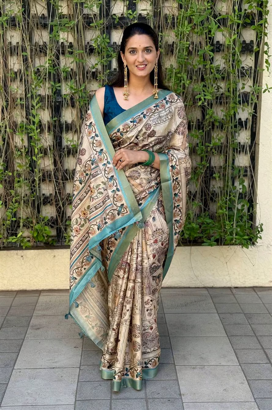 Woman in traditional Kalamkari print saree with Zari Border.