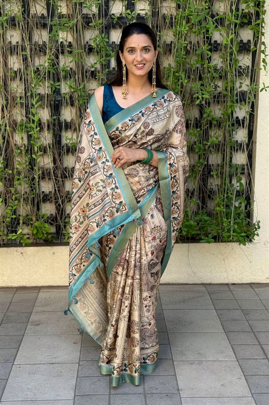 Woman in traditional Kalamkari print saree with Zari Border.