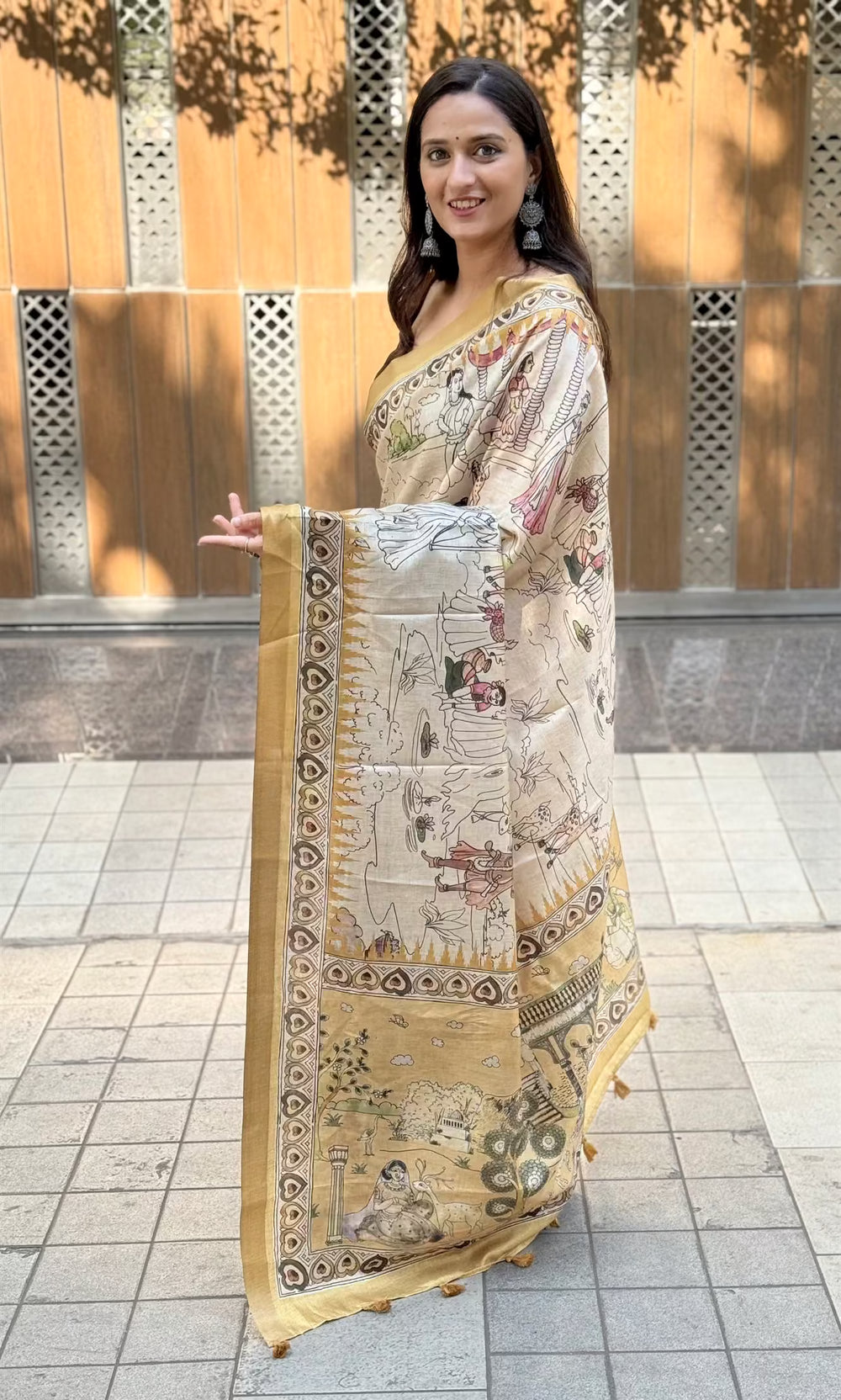 Woman weaaring Antique Gold saree by Ethnic Today.