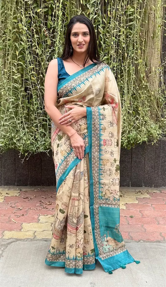 Woman wearing a Kalamkari Figure in Beige colour with Cyan border saree.