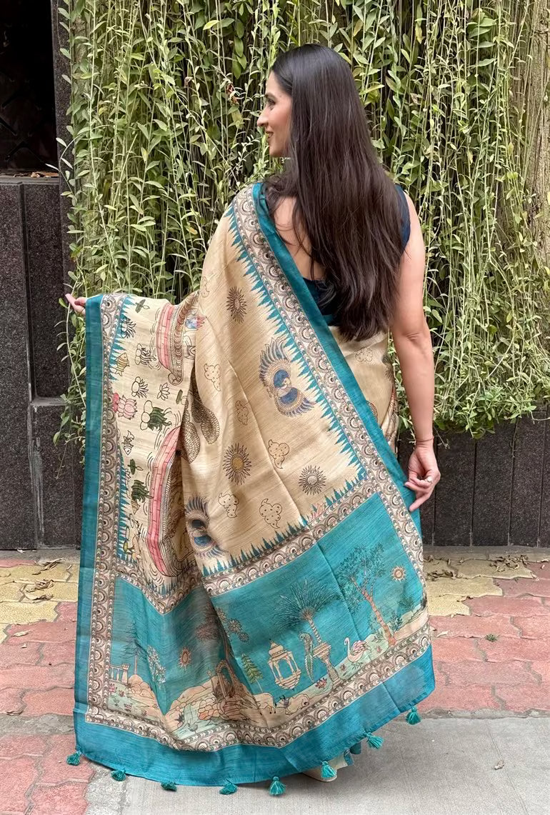 Woman in Kalamkari Figure in Beige colour with Cyan border saree.