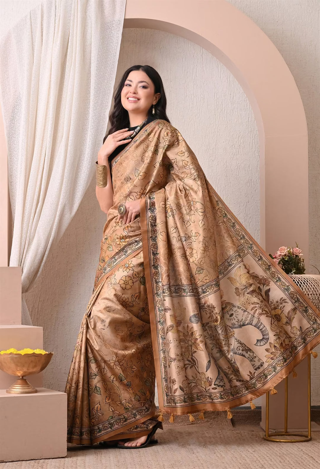 Woman wearing a Yellow Elephant Pallu Kalamkari print saree.