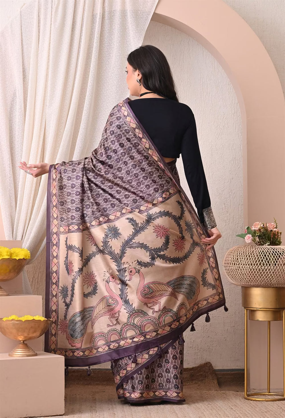 Woman in Ikkat Pattern in Purple & Cream colour with Kalamkari pallu saree.