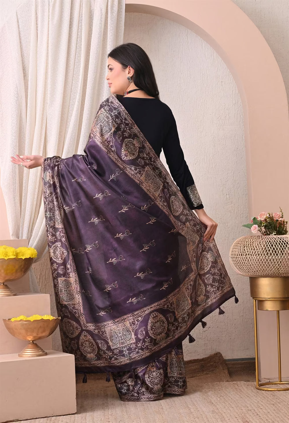 Woman in Floral butta in Dark Purple saree with printed border.