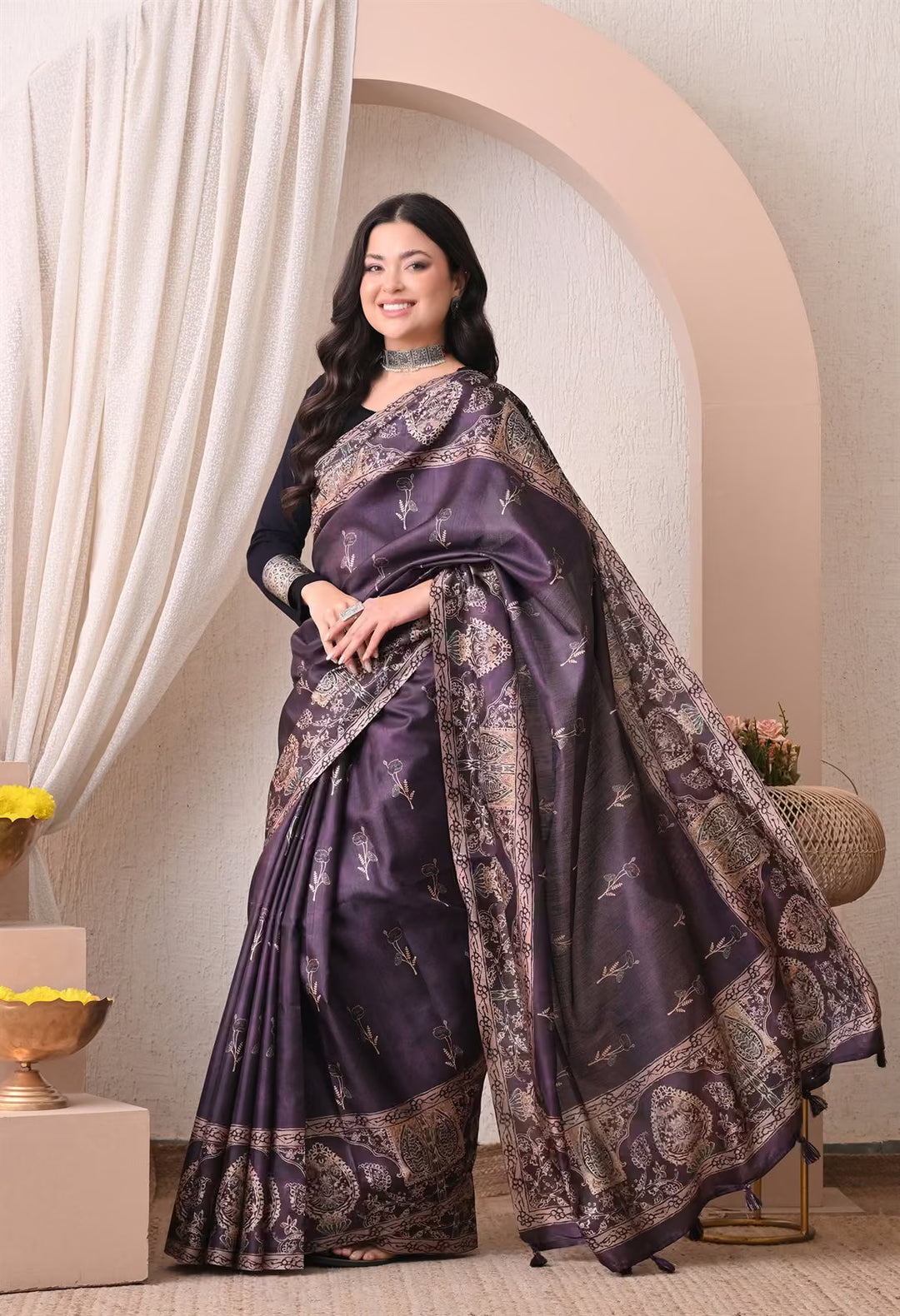 Woman wearing a Floral butta in Dark Purple saree with printed border.