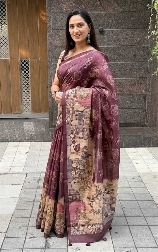 Woman wearing a Rich Wine with Beige Kalamkari printed pallu saree.