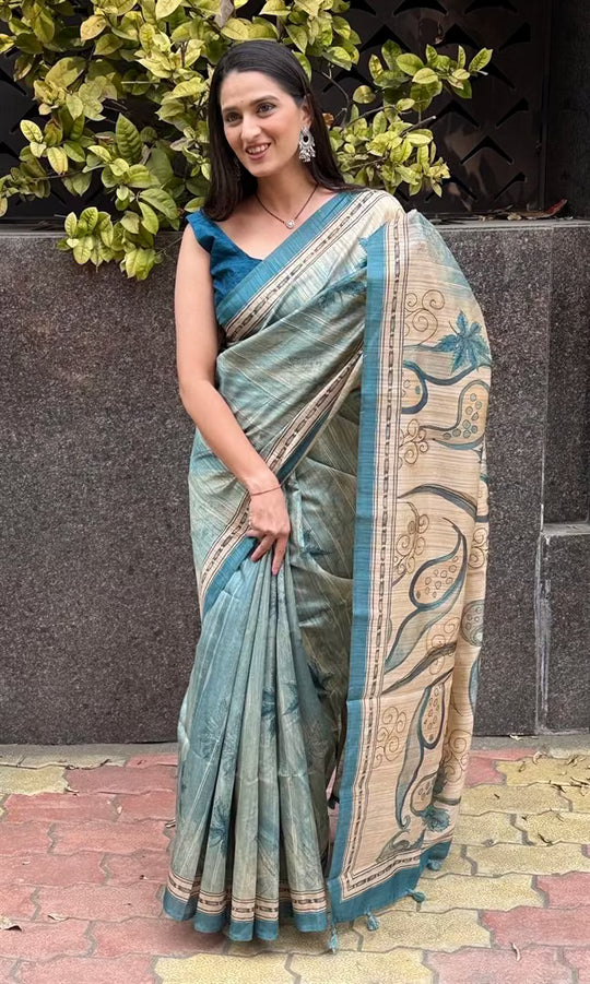 Woman wearing a Cyan & Beige Botanical Soft silk saree.