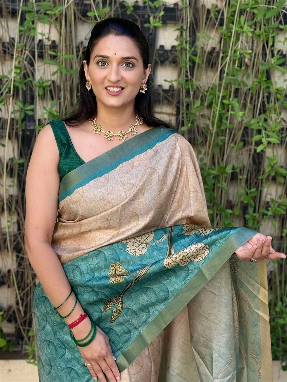Woman wearing Teal Green Saree in Botanical Print With Zari Border in Soft Silk fabric.